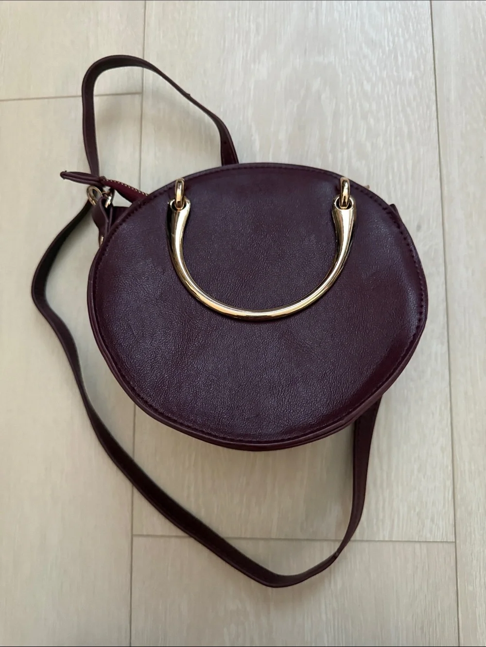 Round Crossbody Bag in Plum with Gold Accents